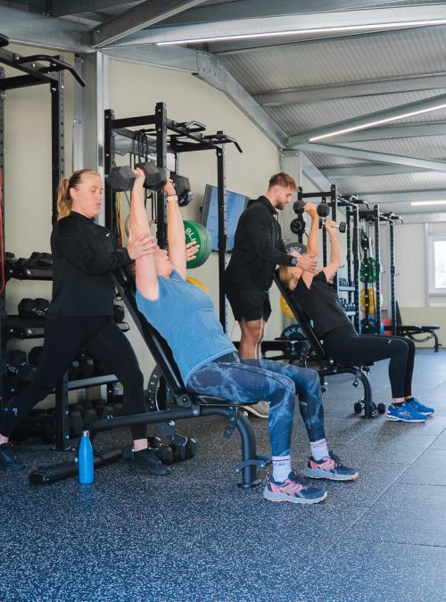 2 people working out with personal trainers