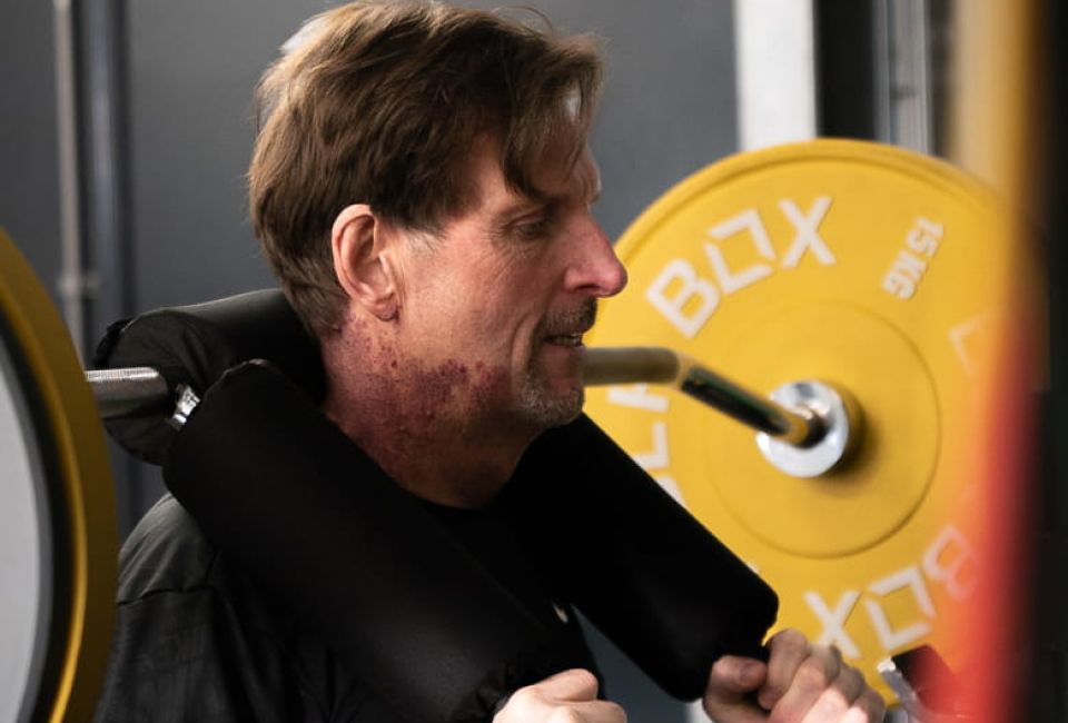 Man working out with squat rack